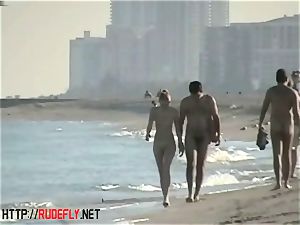 voyeurism at a molten nudist couple on the beach